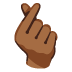 hand with index finger and thumb crossed: medium-dark skin tone on Google
